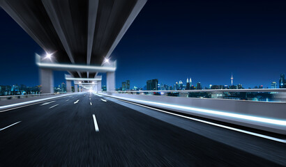 Highway overpass motion blur with city skyline background. Night scene.