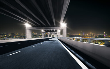 Motion blur highway overpass with city background. Night scene
