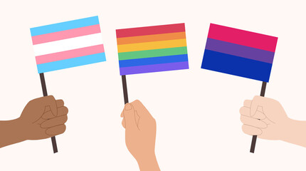 LGBT flags, gay flag, bi flag and trans flag banner. People celebrating equality with LGBT flags.