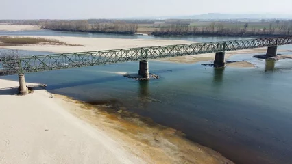 Fotobehang problems of drought and aridity in the almost waterless Po river with large expanses of sand and no water - climate change and global warming, Drone view in Ponte bella Becca Pavia Lombardy and Ticino © andrea