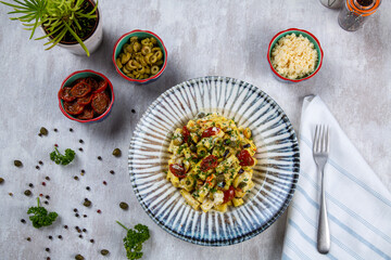 Italian pasta with bechamel sauce and vegetables. Vegan pasta made of dried tomatoes, broccoli,...