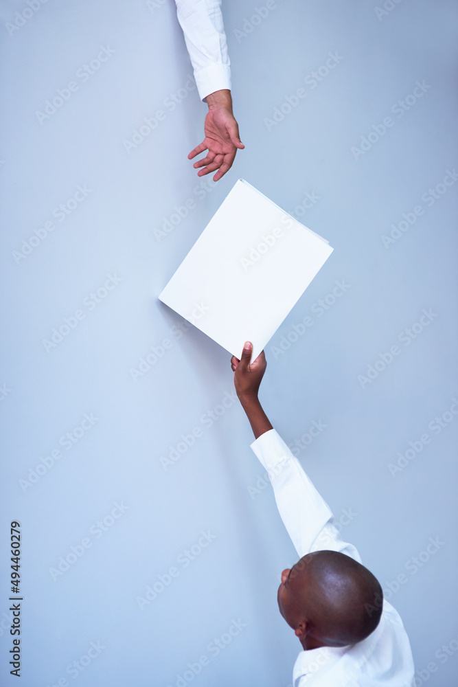 Aufkleber passing the matter on to management. shot of a young businessman reaching up to pass a file to his u