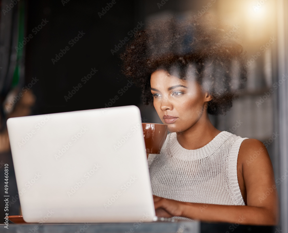 Poster ordering another batch of coffee beans online. shot of a young business owner using a laptop while s