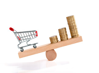 Inflation. Shopping and money. Coin and shopping trolley on wooden seesaw. Supermarket shopping...