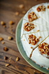 Beutifly decorated Hazelnut caramel cake on wooden background with coffee, coffee shop food.