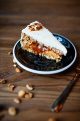 Beutifly decorated Hazelnut caramel cake on wooden background with coffee, coffee shop food.