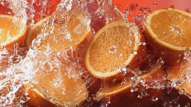Slow Motion Shot of Water Splashing through Orange Slices