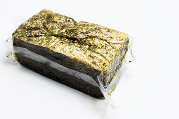 Close-up of vacuum sealed smoked tofu isolated on white background.