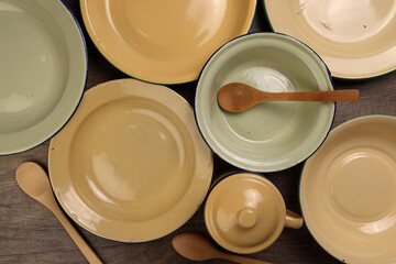 Varity of wooden metal spoon on enamel tin food plate pot bowl retro vintage tableware dinnerware...