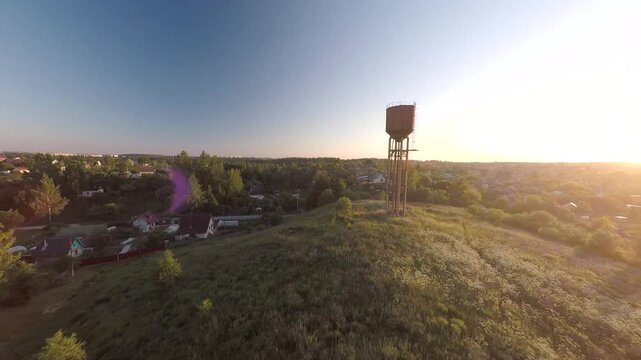 Flying on a drone, flying over a blooming summer field at sunset in the sunlight.Flying with birds. Flight at sunset. A sunny summer day. Aerial photography . FPV flights. High-speed flights.	
