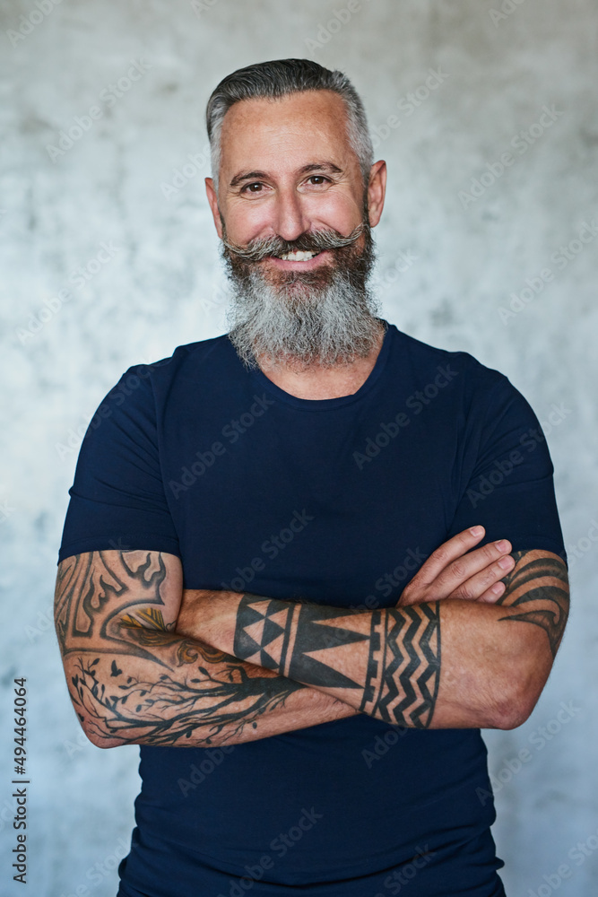 Poster fierce but always a gentleman. portrait of a confident middle aged man standing with his arms folded