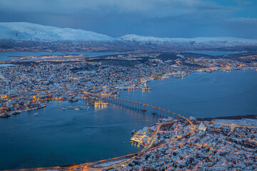 Aerial view of beautiful winter landscape of snow covered town Tromso
