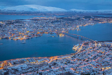 Fototapeta premium Aerial view of beautiful winter landscape of snow covered town Tromso