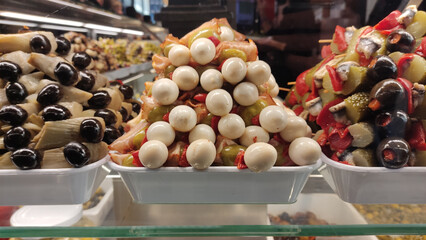 Closeup of delicious snacks with pickles, quail eggs and olives on the counter
