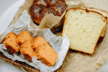 There are two loaves of bread and a few crackers on the table.