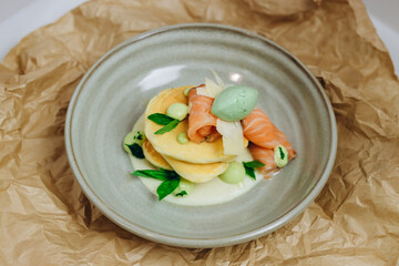 The waiter served the dish to the visitor of the cafe.