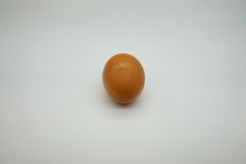 Shiny brown-shelled chicken eggs placed vertically on a white background. organic eggs on the table
