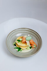 The chef is demonstrating a new dish to the other chefs of the restaurant.