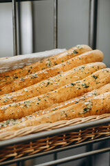 There are a lot of fresh made baguettes in bread basket.