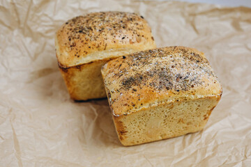There are two rectangular breads on the paper which is on the table