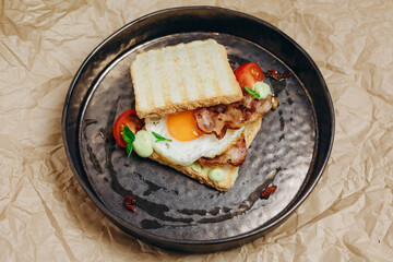 The waiter is served the dish in plate on the wonderful table.