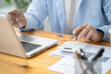 Business man working by using laptop computer Hands typing on a keyboard. Professional investor working new start up project. business planning in office. Technology business Concept.