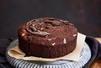 Healthy chocolate cake with almonds non sugar on a plate on the old wooden background. Selective focus. Keto diet.
