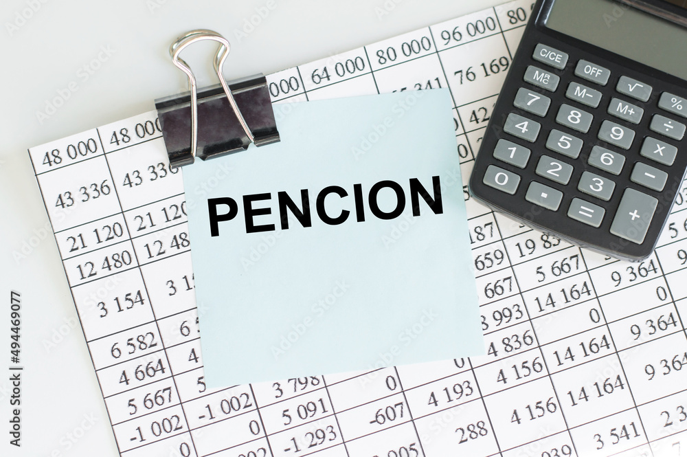 Poster a card with the text pension on a table with reports and a calculator