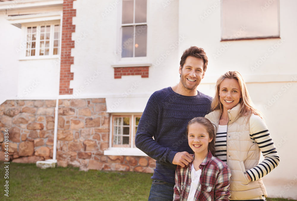 Wall mural Home sweet home. A portrait of a happy family posing outside their home.