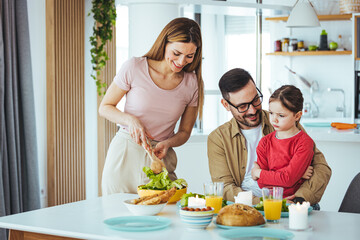 Healthy food at home. Happy family in the kitchen. Mother and child daughter are preparing a real meal. A father loves to watch his beautiful daughter! The concept of a happy family