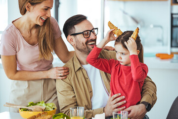 Healthy food at home. Happy family in the kitchen. Mother and child daughter are preparing a real meal. A father loves to watch his beautiful daughter! The concept of a happy family