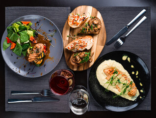 Top view of various Italian dishes with red and white wine
