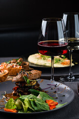 Top view of various Italian dishes with red and white wine