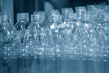 The empty PET bottles  on the conveyor belt for filling process in the drinking water factory.