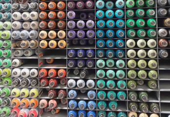 Abstract colourful spray bottles on the shelf