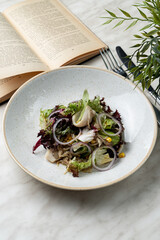 A portion of seafood salad in a cozy cafe, lunch setting with book and plants on table