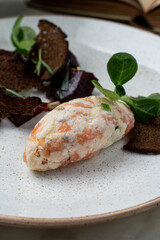 Red fish patty with rye croutons and sprouts, fine dining serving of modern russian restaurant, top view on marble table