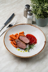 Goose fillet with boiled carrot and cranberry sauce