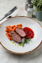 Confit duck breast with berry sauce, light beautiful commercial photo, close up, pink bloody cut