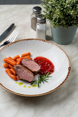 Confit duck breast with berry sauce, light beautiful commercial photo, close up, pink bloody cut