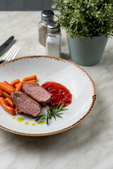 Confit duck breast with berry sauce, light beautiful commercial photo, close up, pink bloody cut