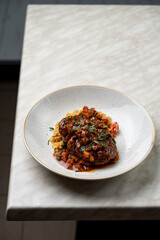 Lentils osso buco with braised beef and thick sauce, appetizing menu photo