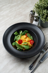 Rich cream mango risotto with prawns, modern fusion cuisine, bright on black, appetizing photo