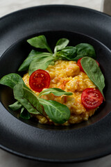 Rich cream mango risotto with prawns, modern fusion cuisine, bright on black, appetizing photo