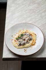 Mashed potato with stewed chicken liver and rich cream sauce, low contrast calm menu photo