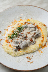Mashed potato with stewed chicken liver and rich cream sauce, low contrast calm menu photo