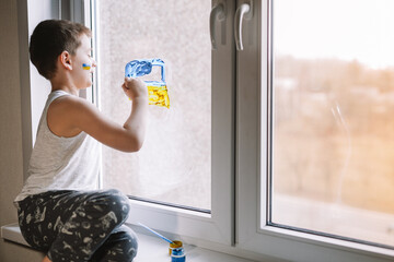 frustrated poor boy protests against the military conflict, cries, worries and is afraid. The...