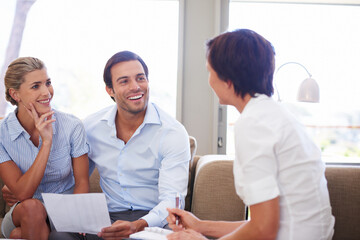 Taking charge of their finances. Shot of a couple meeting with their financial advisor.