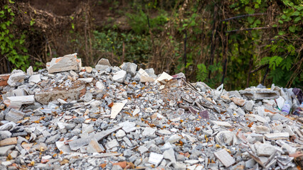 Close-up view of concrete rubble, bricks and small pieces of wood.