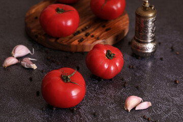 tomatoes with garlic and spices on a dark background